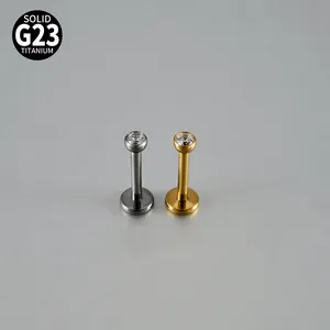 Detailed view of G23 titanium labret studs with round zircon stones in silver and gold