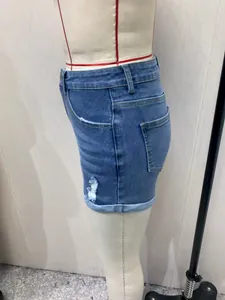 Vista lateral detallada de pantalones cortos de mezclilla azul de cintura alta con dobladillo