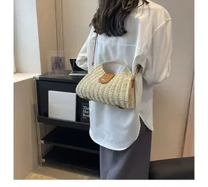 Back view of a French style woven paper-rope crossbody bag on model with a retro design