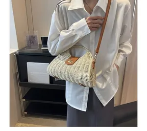 Fashionable French style woven paper rope crossbody bag worn by a model in lifestyle setting