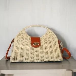 Detailed view of handmade paper rope woven dumpling bag with vintage leather strap