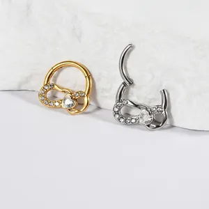 Close-up of stainless steel nose rings with heart zircon design in gold and silver finish