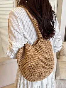 Minimalist brown hand-woven straw shoulder tote bag for women shown from back on model