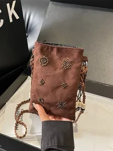 Vintage brown suede phone bag with beaded accents and braided strap