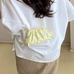 Minimalist small yellow polka dot crossbody bag for women in a summer leisure design