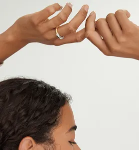 Detailed lifestyle view of a minimalist two-tone polished sterling silver ring on a finger.