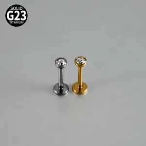Close-up of G23 titanium internal thread labret studs with round clear zircons for piercings.