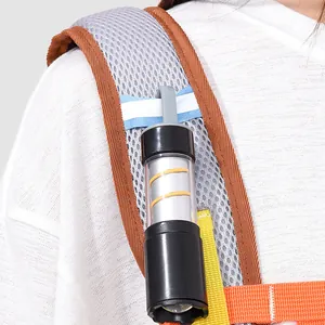 Close-up of portable flashlight attached to colorful backpack mesh shoulder strap