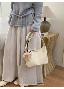 Minimalist leather hobo shoulder bag for women, chic underarm purse with cute charm.