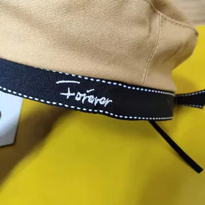 Close-up detail of the 'forever' embroidery on a stylish beige Japanese beret hat