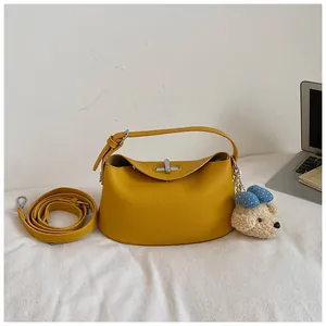 Premium yellow pebbled leather bucket bag with a cute puppy charm and extra strap
