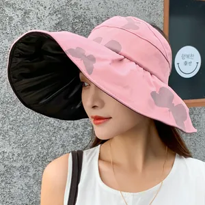 Stylish pink wide brim sun hat for women with butterfly print and black vinyl lining