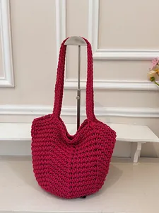 Handmade fuchsia crochet shoulder bag featuring a minimalist tote bag silhouette