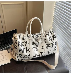 Stylish white graffiti print duffle bag for travel and gym, large capacity design.