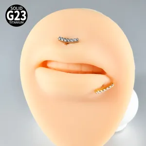 Close-up of crescent G23 titanium lip studs with sparkling clear cubic zirconia