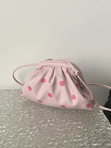 Chic pink polka dot pouch shoulder bag with pleated design and thin crossbody strap