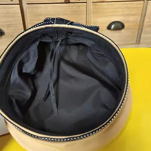 Detail view of a Japanese style beret hat showing black interior lining and adjustable strap.