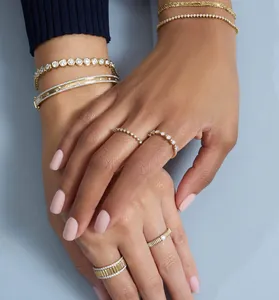 Close-up of elegant gold-plated silver rings and bracelets with shimmering zircons