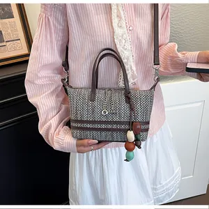 Close-up of a vintage woven bucket bag with chain and colorful bead charms