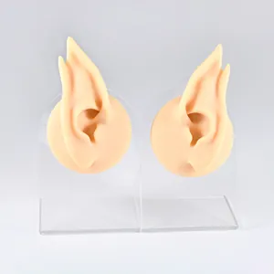 Pair of silicone elf ear models on acrylic stands for jewelry and piercing display