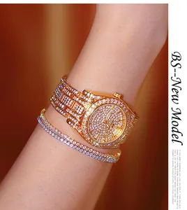 Macro view of luxury gold-tone women's watch with full rhinestone embellishment and diamonds