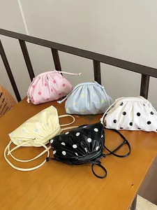 Collection of five colorful polka dot cloud crossbody bags in casual minimalist style