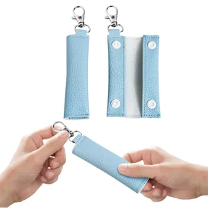 Blue lychee pattern leather earphone organizer with metal keychain clasp detail view.