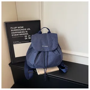 Detailed view of the blue checkered pattern on a stylish casual women's backpack