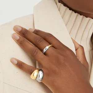 Minimalist S925 sterling silver two-tone polished dome rings shown on a model's hand