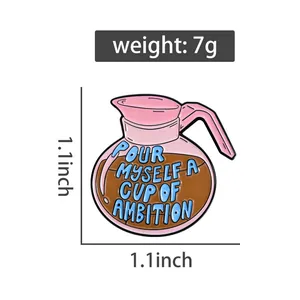 Close-up detail of a coffee pot enamel pin with motivational slogan and dimensions