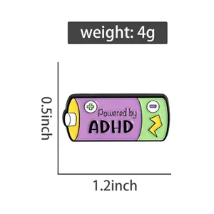 Close-up of Powered by ADHD battery enamel pin with 1.2x0.5 inch dimensions