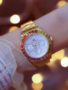 Close-up of gold-tone women's watch with rainbow gemstone bezel and rhinestone dial.