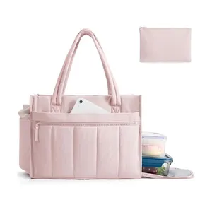 Detail of pink quilted multi-functional tote bag showing laptop and lunch storage