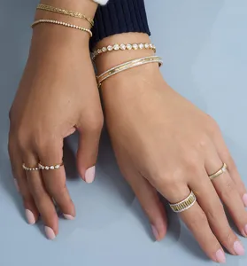 Detailed view of elegant gold-plated sterling silver rings and bracelets with zircons