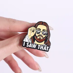 Detailed view of funny Jesus enamel pin badge with sunglasses and I SAW THAT slogan text