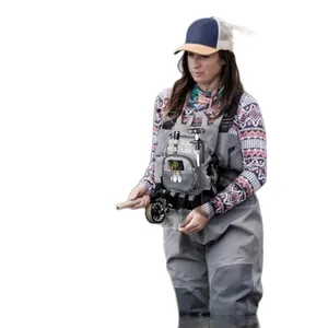 Grey waterproof fly fishing chest pack shown worn by a female model in a fishing scene.