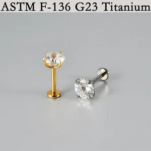 Close-up of G23 titanium labret studs with sparkling prong-set round cubic zircons