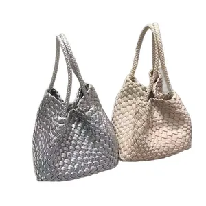 Pair of stylish woven bucket bags in silver and beige with braided top handles