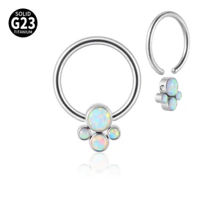 Detailed view of solid G23 titanium septum ring with a cluster of vibrant white opals.