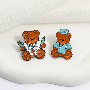 Close-up of cute medical theme teddy bear enamel pins for doctors and nurse accessories