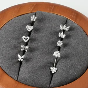 Collection of silver G23 titanium piercing studs with heart, star, and butterfly designs
