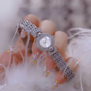 Detailed macro view of a luxury silver women's watch with sparkling crystal bezel