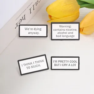 Detail view showing four rectangular enamel pins with humorous English text quotes