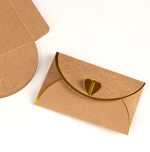 Close-up of kraft paper envelope with elegant gold heart-shaped foil closure