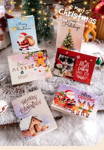 Detailed view of assorted creative Christmas greeting cards in a festive snowy scene