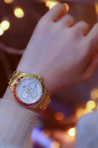 Macro detail of luxury gold watch with rainbow crystal bezel and rhinestone dial