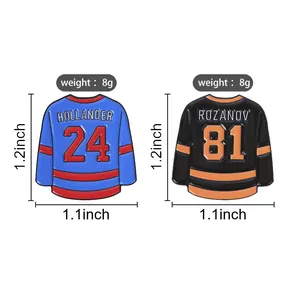 Close-up of two hockey jersey enamel pins with Hollander 24 and Rozanov 81 numbering
