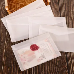 Detail of translucent vellum envelope with an elegant red wax seal on wooden desk