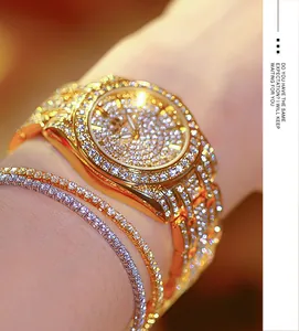 Detail view of luxury gold FA1643 women watch with full sparkling crystals on wrist.
