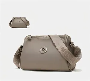 Detail of khaki water-repellent nylon messenger bag with wide shoulder strap